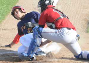 Photo by Kelly Sullivan/ Peninsula Clarion Peninsula Oiler's umpire Lukas Hermanson gets Fairbanks Goldpanner's Renae Martinez out at home base Thursday, June 11, 2015, at Coral Seymour Ballpark in Kenai, Alaska.