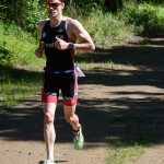 Photo by Rashah McChesney/Peninsula Clarion M. Scott Moon photographs the "MoonCheyEttes" after the final leg of their race on Sunda yJune 14, 2015 at the Tri the Kenai triathlon in Soldotna, Alaska.