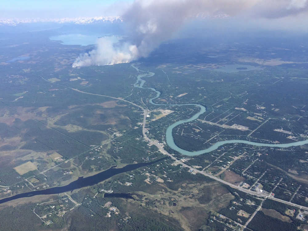 Photo by Kelly Sullivan/ Peninsula Clarion At least one home and one vehicle were consumed by the Card Street Fire on Cottontree Lane Monday, June 15, 2015, in Sterling, Alaska.