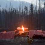 Photo by Rashah McChesney/Peninsula Clarion A Homer Electric Association lineman lights a power line during the early morning hours of Wednesday June 17, 2015 as crews worked on the lines heading into the Kenai Keys subdivision in Sterling, Alaska where the Card Street wild fire has burned thousands of acres and is threatening hundreds of homes.