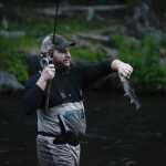 Photo by Rashah McChesney/Peninsula Clarion An angler works to pop a smaller fish off of his hook during the Russian River sockeye salmon opener on Thursday June 11, 2015 near Cooper Landing, Alaska.