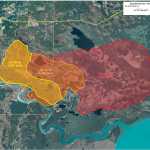 Photo by Rashah McChesney/Peninsula Clarion  Patrick "PBun" Madros and Fred Alexi, both of Kaltag work to put out a hot spot off of Kamloops Road on Thursday June 18, 2015 near the Kenai Keys in Sterling, Alaska. Authorities have lifted an evacuation order in a portion of the keys after the threat of the 9,000 acre Card Street fire receded.