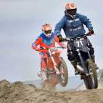 Photo by Rashah McChesney/Peninsula Clarion  Racers land jumps during a state motocross meet on Saturday June 20, 2015 at the Twin City Raceway in Kenai, Alaska.