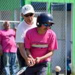 Photo by Rashah McChesney/Peninsula Clarion  A caretaker helps Jacob Dotomain, of Seward, bat during the annual World Series of Baseball event for community members with special needs on Friday June 19, 2015 in Soldotna, Alaska.