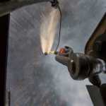 A "Bambi Bucket," hanging from an Alaska Army National Guard Black Hawk helicopter, releases more than 700 gallons of water onto the Stetson Creek Fire near Cooper Landing, Alaska, June 17. Two AKARNG Black Hawk helicopters flew 200 bucket missions total, dumping more than 144,000 gallons of water on the 300-acre Stetson Creek Fire on the Kenai Peninsula portion of the Chugach National Forest. (U.S. Army National Guard photo by Sgt. Balinda O'Neal)