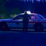 Photo by Rashah McChesney/Peninsula Clarion  A Soldotna police officer returns to his patrol car after responding to a high-speed chase that ended on Funny River Road early Wednesday June 24, 2015 in Soldotna, Alaska.