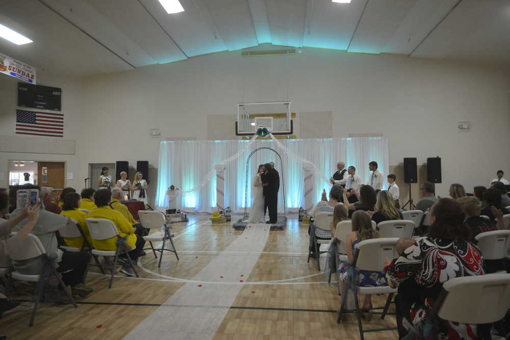 Photo by Megan Pacer/ Peninsula Clarion  Bob and Hope Hensler marry in front of friends, family, community members and firefighters during a Sunday afternoon ceremony at the Sterling Community Center.