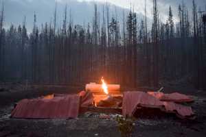 Photo by Rashah McChesney/Peninsula Clarion  A structure on Slough Avenue burns late into the night after the Card Street wild fire burned near the Kenai Key subdivision on June 17, 2015 in Sterling, Alaska. The flames burned high from a damaged gas line.