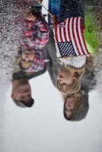 Photo by Rashah McChesney/Peninsula Clarion  Kenai City Manager Rick Koch smokes a cigar while driving a '73 Mustang with the Kaknu Kruzers car club during the annual Independence Day parade on Saturday July 4, 2015 in Kenai, Alaska.
