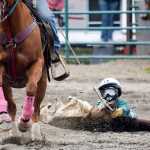 Photo by Rashah McChesney/Peninsula Clarion Jared Stouff, of Anchorage, stands on Sierra and Lacey as he demonstrates a type of trick riding for the audience at the Ninilchik Rodeo on Sunday July 5, 2015 in Ninilchik, Alaska.