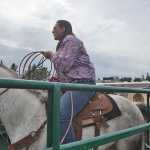 Photo by Rashah McChesney/Peninsula Clarion  Aidan Fry, of Palmer, takes a ride on a calf hide as his father William Fry takes off during a hide racing competition on Sunday July 5, 2015 at the Ninilchik Rodeo in Ninilchik, Alaska.