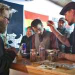 Maureen Hensley, of Kenai, uses her spare time to paint a mural on the windows of Green Rush Events Clubhouse on Saturday in Kenai. Photo by Megan Pacer/Peninsula Clarion