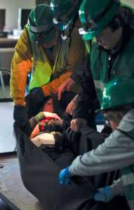 Photo by Rashah McChesney/Peninsula Clarion A group of Community Emergency Response Team trainees transport a mock earthquake victim in a blanket during a disaster drill Saturday July 12, 2014 in Soldotna, Alaska. 10 communities on the Kenai Peninsula have CERT members.