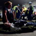 Photo by Rashah McChesney/Peninsula Clarion  Community Emergency Response Team trainees transport mock earthquake victims to a staging area during a disaster drill Saturday July 12, 2014 in Soldotna, Alaska.
