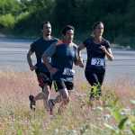 Photo by Rashah McChesney/Peninsula Clarion Racers run down the side of the Kenai Spur Highway during the 5k portion of the annual Rotary Unity Run on Saturday July 11, 2015 in Soldotna, Alaska.