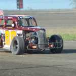 Photo by Ben Boettger/Peninsula Clarion Bryan Barber pilots his Legends car around Twin City Raceway on Saturday.