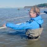 Ben Boettger/Peninsula Clarion Jill Brown (foreground) dipnets alongside Chelsee Largo (background) on Kenai's north beach on Sunday July 19.