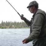 Ben Boettger/Peninsula Clarion Art Baker twitches his hook at the end of a drift by pulling out the line with his hand on the bank of the Kenai, behind the Kenai River Center in Soldotna, on Tuesday, July 21.