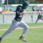 hustles into first base  during a game against the Anchorage Bucaneers on Thursday, July 23. Alas, first baseman  has caught the ball, and  is out.