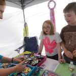 Megan Pacer/Peninsula Clarion Chainsaw scultpor Eric Benson, owner of the Dreamer's Wood chainsaw sculpting business in Sterling, carves a bear during the Sawfest Chainsaw Carving Competition in Centennial Park on Friday, July 25.