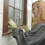 Photo by Megan Pacer/Peninsula Clarion Katilin Weeks, of West Virginia, scrapes paint residue off a window of the Holy Assumption of the Virgin Mary Russian Orthodox Church Tuesday morning in Old Town Kenai.
