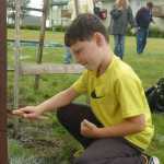 Photo by Megan Pacer/Peninsula Clarion Ethan Weeks, of West Virginia, applies a layer of paint to the trim of the Holy Assumption of the Virgin Mary Russian Orthodox Church on Tuesday morning in Old Town Kenai.