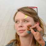 Photo by Megan Pacer/Peninsula Clarion Julia Zagaya, of Tennessee, holds still while her face is painted during Salmonfest on Friday July 31, 2015 in Ninilchik, Alaska.