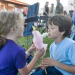 Photo by Megan Pacer/Peninsula Clarion Reece Solomon, 7, enjoys some cotton candy with his sister, 6-year old Hattie Solomon, on the lawn in front of Salmonfest's main stage on Friday July 31, 2015 in Ninilchik, Alaska.