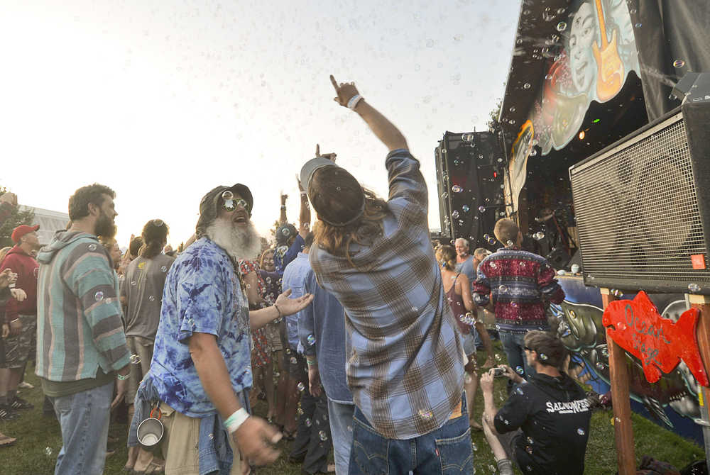 Photo by Megan Pacer/Peninsula Clarion Dozens of people dance among a cloud of bubbles released in front of Salmonfest's main stage on Friday July 17, 2015 in Ninilchik, Alaska.