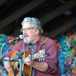 Photo by Megan Pacer/Peninsula Clarion Seattle musician Jim Page serenades an audiance as the first performer on Salmonfest's main stage on Saturday, Aug. 1, 2015 in Ninilchik, Alaska.