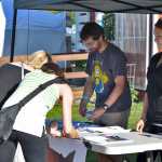 Photo by Megan Pacer/Peninsula Clarion Bryan Goldstein (left) and Alexandra Guilford (right) share their message about proposed mines in British Columbia that would threaten Alaska's salmon rivers with pasersby on Friday July 31, 2015 in Ninilchik, Alaska.