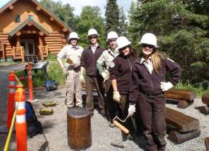 Back to front, Nathan Lervold, Talon Musgrave, Atom Skeeba, Elizabeth Keys and Amber Hamar repair benches used for outdoor educational programs at the Kenai National Wildlife Refuge Headquarters. (Photo courtesy Kenai National Wildlife Refuge)