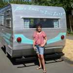 Deanna Wohlgemuth stands outside her camper on July 17, 2015 in Vancouver, Wash.   Wohlgemuth's dubbed the camper "Matilda," which is a 1963 16-foot Aristocrat camper she rescued from the junk heap, she now rents it our for camping and events. (Natalie Behring/The Columbian via AP) MANDATORY CREDIT