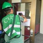 Photo by Megan Pacer/Peninsula Clarion Jeremiah Millette, a member of the Kenai Peninsula Borough's most recent Community Emergency Response Team class, labels the front door of Soldotna Prep as he and other classmates begin an earthquake simulation at the end of the course. The exercise was held on Saturday, Aug. 8, 2015 at Soldotna Prep School in Soldotna, Alaska.