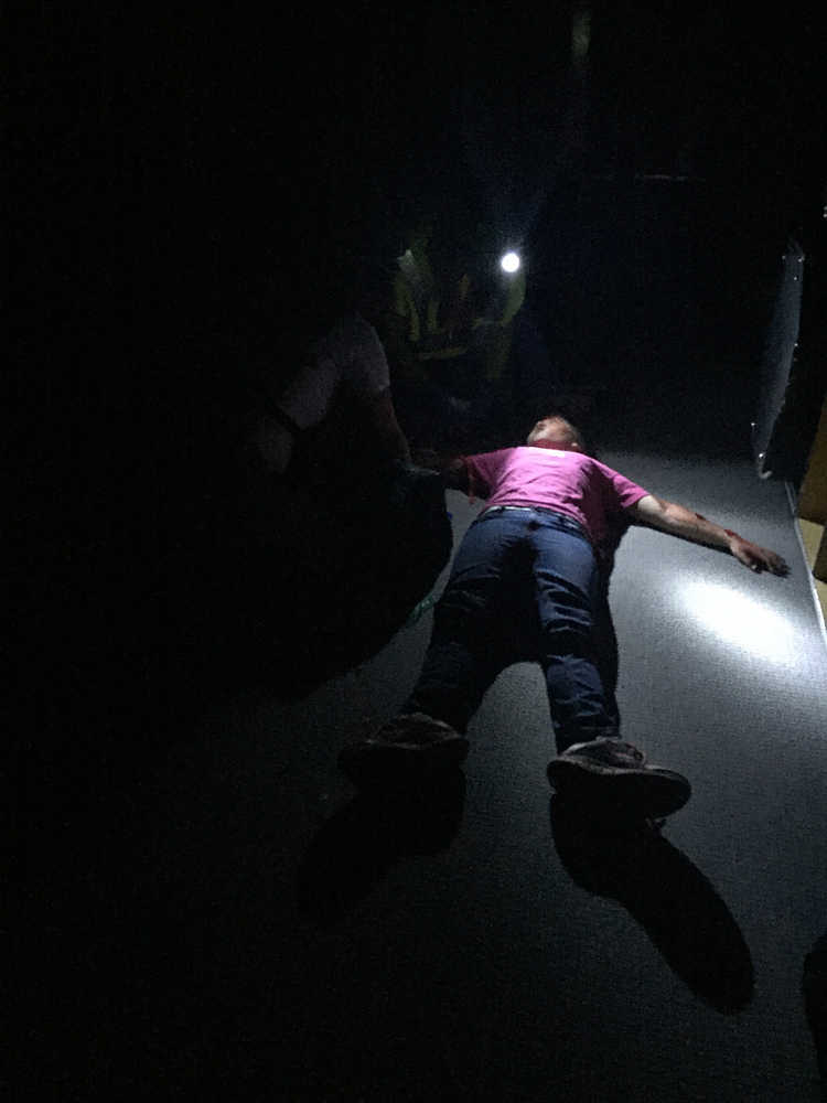 Photo by Megan Pacer/Peninsula Clarion Kellee Martin, 11, pretends to be an injured victim of an earthquake for a Community Emergency Response Team disaster simulation held on Saturday Aug. 8, 2015, at Soldotna Prep School in Soldotna, Alaska.