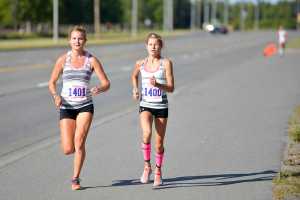 Photo by Rashah McChesney/Peninsula Clarion  Taylor Ostrander and Allie Ostrander lead the 10k portion of the Run for Women on Saturday August 8, 2015 in Kenai, Alaska.