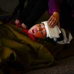 Photo by Rashah McChesney/Peninsula Clarion  Kellee Martin, 11, lays on the floor of the Soldotna Prep lobby feigning injury during a Community Emergency Response Training drill on Saturday August 8, 2015 in Soldotna, Alaska.