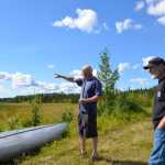 Photo by Megan Pacer/Peninsula Clarion Kenny Merkes (left) and his neighbor Tommy Patterson (right) visit the site of an attempted theft of Merkes' boat motor on Wednesday Aug. 12, 2015 on Moose River in Sterling, Alaska. Two men in a yellow canoe attempted to take the boat motor before abandoning it in the canoe and fleeing into the woods near Moose River.