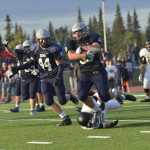 Ben Boettger/Peninsula Clarion  evades a would-be tackler during a game at Soldotna High School on Friday, August 14.