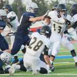 attempts to evade Soldotna defense during a game at Soldotna High School on Friday, August 14.