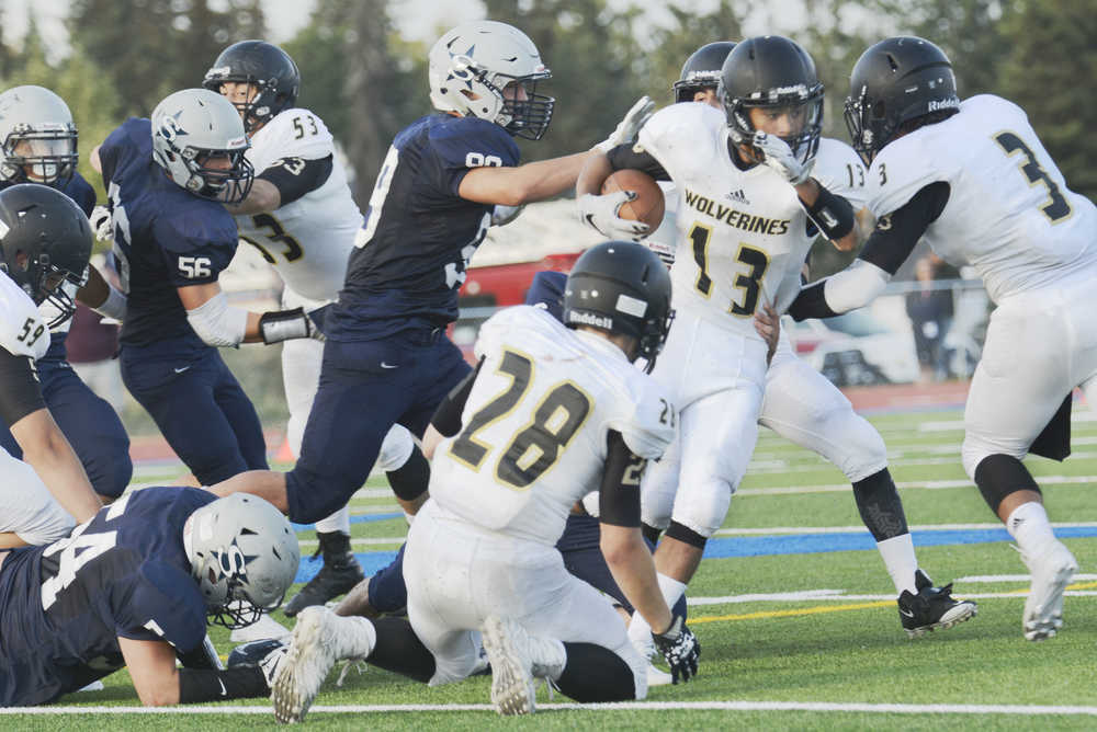attempts to evade Soldotna defense during a game at Soldotna High School on Friday, August 14.