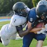 tackles  during a game at Soldotna High School on Friday, August 14.