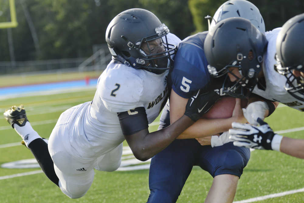 tackles  during a game at Soldotna High School on Friday, August 14.