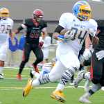 Ben Boettger/Peninsula Clarion  attempts to get past  during a game at Kenai Central High School on Saturday, August 14.