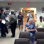 Photo by Megan Pacer/Peninsula Clarion  Several residents prepare to the leave the Kenai Peninsula Borough Assembly Chambers after a public hearing on a proposal to form a special assessment district to help mitigate flooding along Kalifornsky Beach Road on Thursday August 18, 2015 in Soldotna, Alaska.