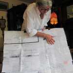 In this Thursday, July 23, 2015 photo, Tandy Wallack looks over a list with some of the family connections that have been identified for a project her travel company, Circumpolar Expeditions, is working on with residents of the Alaska Native village of Diomede, in Anchorage, Alaska. The residents are trying to reconnect with their long-lost relatives from Big Diomede Island, who were moved to Russia's mainland decades ago. One of the goals of the project is to travel to communities in Russia's Chukotka region next year to visit relatives identified through research currently being compiled. (AP Photo/Rachel D'Oro)