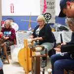 Photo by Kelly Sullivan/ Peninsula Clarion Fireweed Fiber Guild members Lee Choray-Ludden, Martha Merry, Jane Conway answer questions from Telotha Braden and her father Mario Reyna, Friday, August 15, at the Kenai Peninsula Fair in Ninilchik, Alaska.
