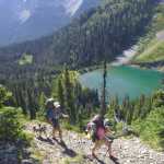 ADVANCE FOR WEEKEND EDTIONS, AUG. 15-16 - In this photo taken July 31, 2015, Samantha Journot, her dog Duke, and Luke Bakken of the Spokane Mountaineers hike the Pacific Crest Trail above Hopkins Lake during their 100-mile trek through the Pasayten Wilderness north of Winthrop, Wash. (Rich Landers/The Spokesman-Review via AP) COEUR D'ALENE PRESS OUT; MANDATORY CREDIT