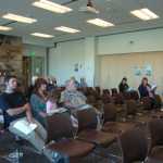 Photo by Megan Pacer/Peninsula Clarion Community members listen to a presentation given by the organizers of Project Homeless Connect during a kickoff meeting held for the event on Thursday, Aug. 20, 2015 at the Soldotna Public Library in Soldotna, Alaska.
