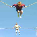 Ben Boettger/Peninsula Clarion  Brothers Grayden (top) and Golden Musgrave bounce on the bungee trampoline at the Ninilchik Fairgrounds during the Kenai Peninsula Fair on Friday, August 21.